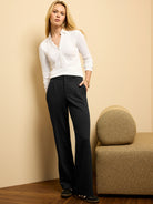Black drapey wide leg trousers with front pleats, shown on a model.