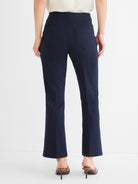 Navy high-waist cropped pants with a slight flare and two prominent rear patch pockets are shown.
