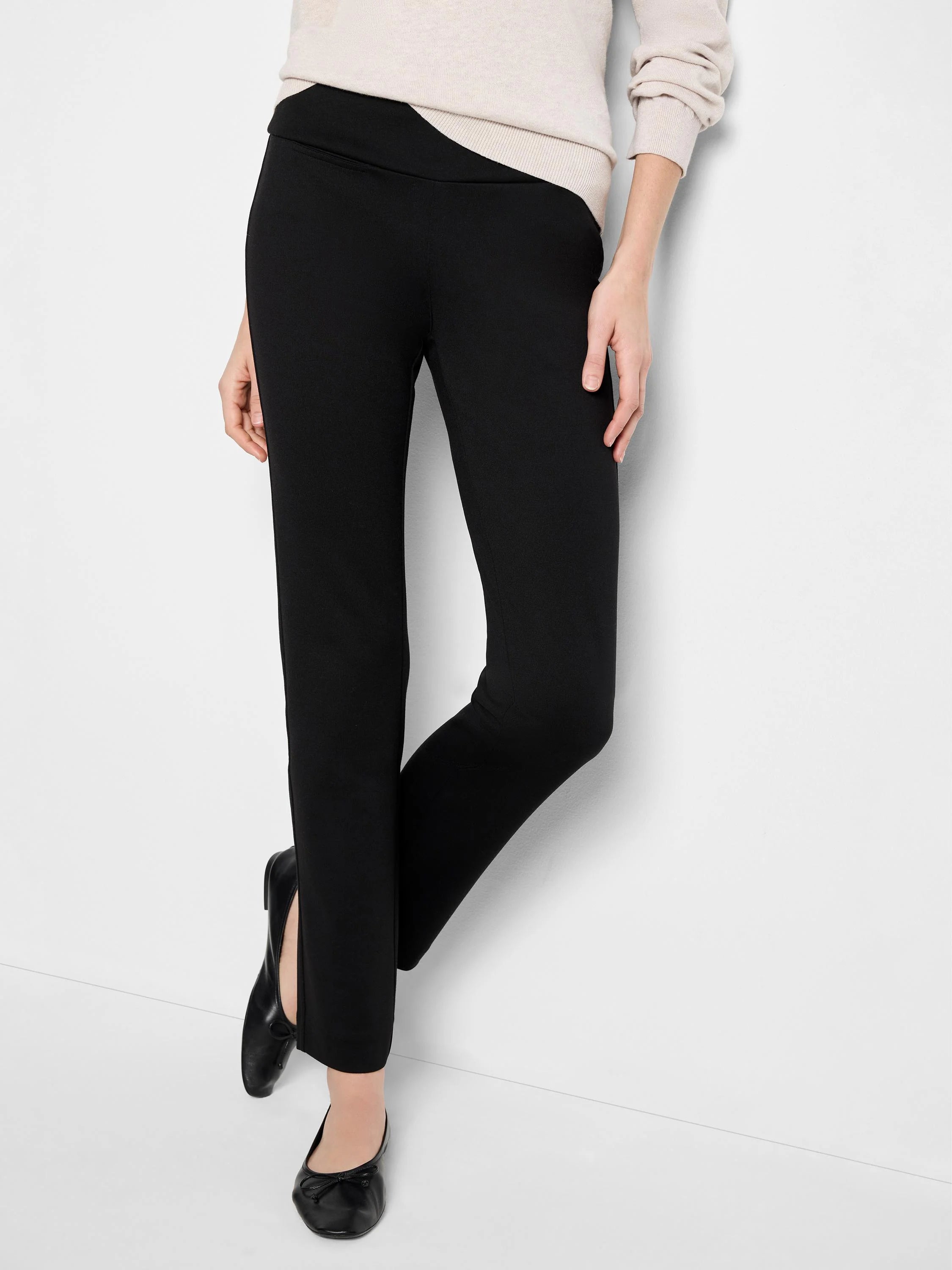 Black straight-leg ponte pants; slight waistband asymmetry.  Model wears neutral top & black flats.