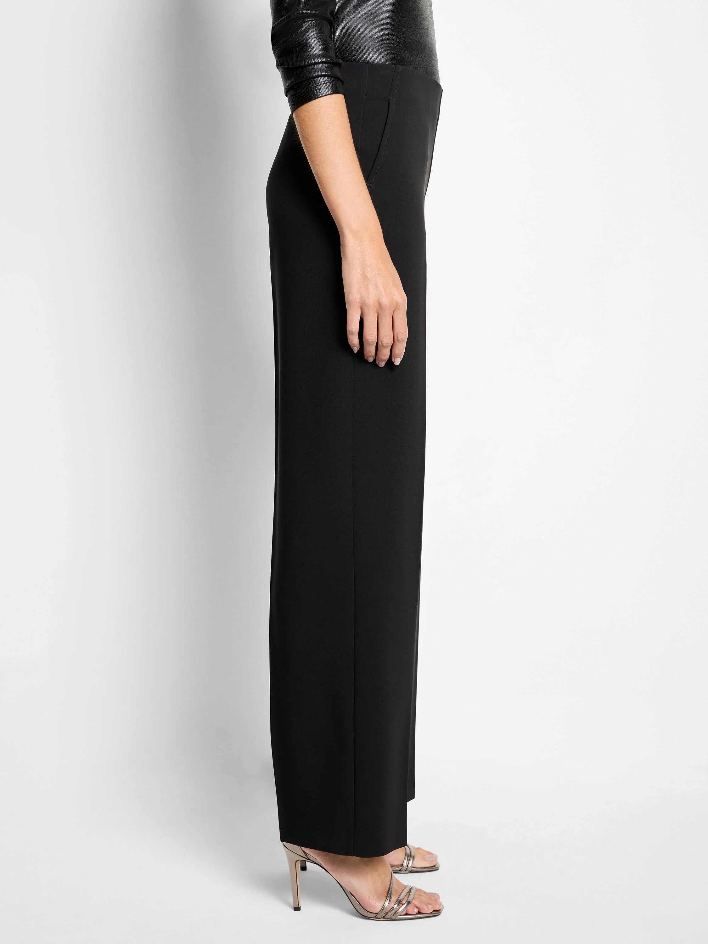 Black wide-leg pant on model, showing a flat front and subtle side pocket.