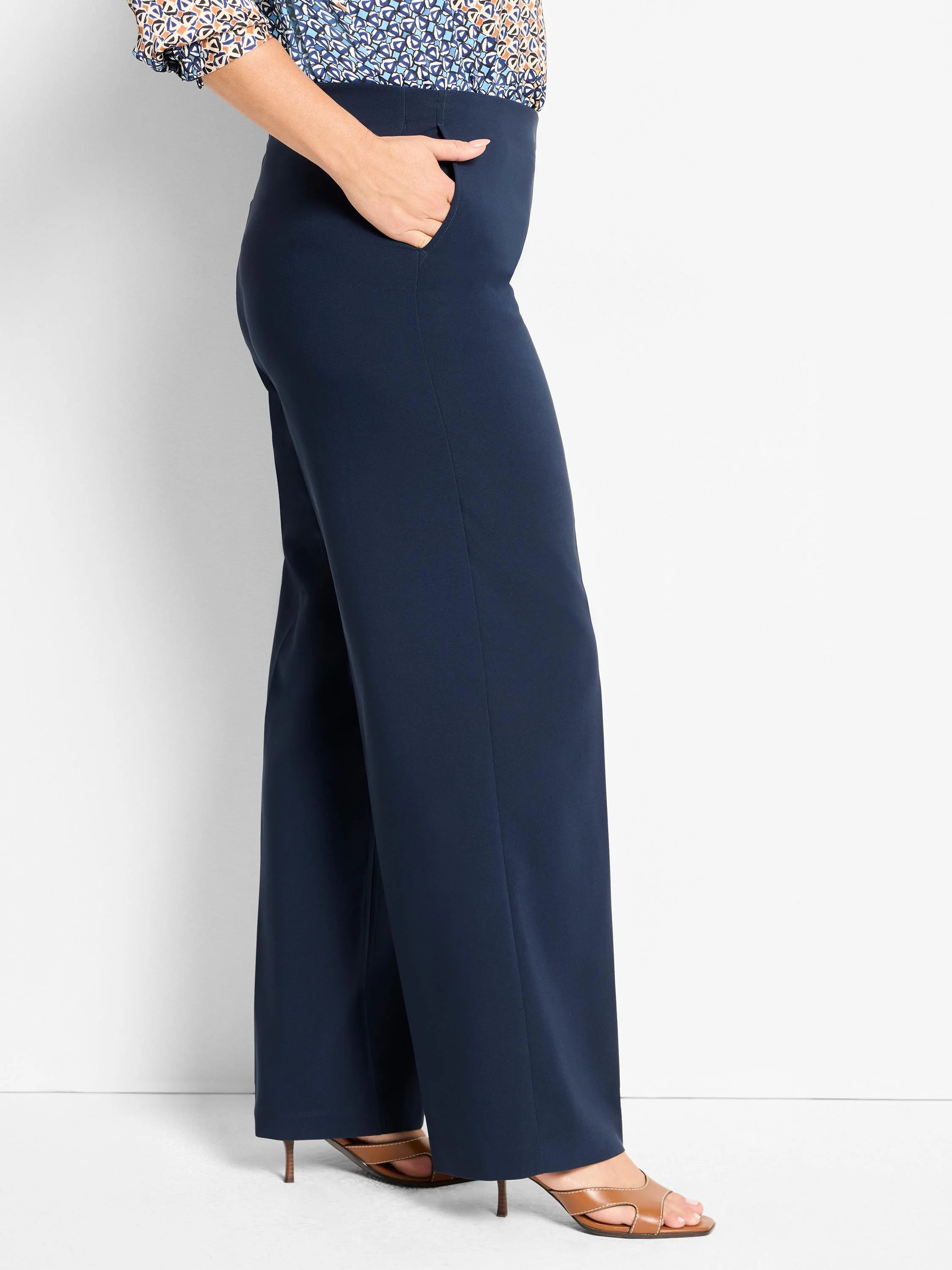 Navy wide-leg, high-waisted pants with front crease and side pockets. Smooth fabric.