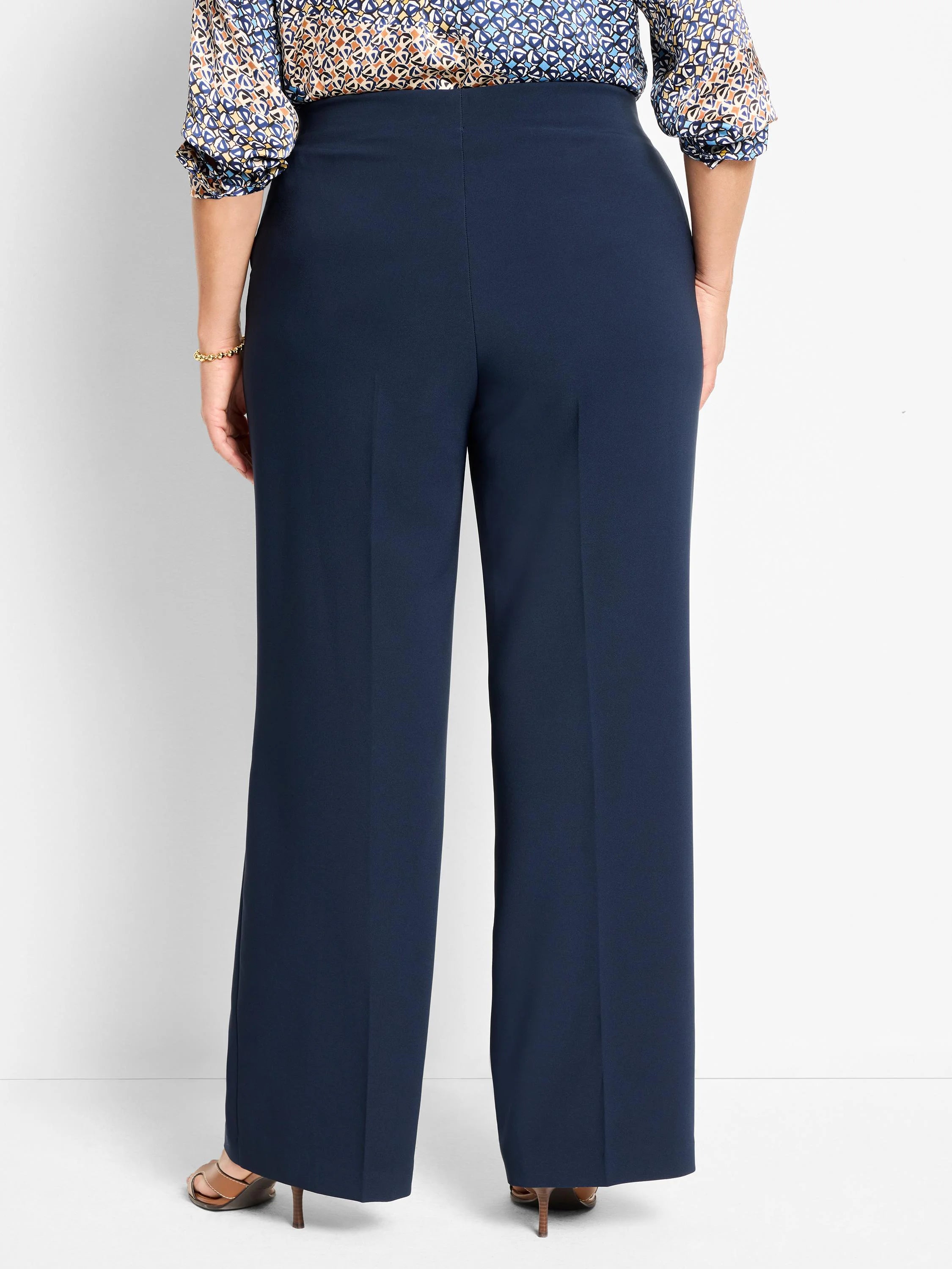 Navy wide-leg pants, high-waisted, sleek fabric. Rear view on a model.
