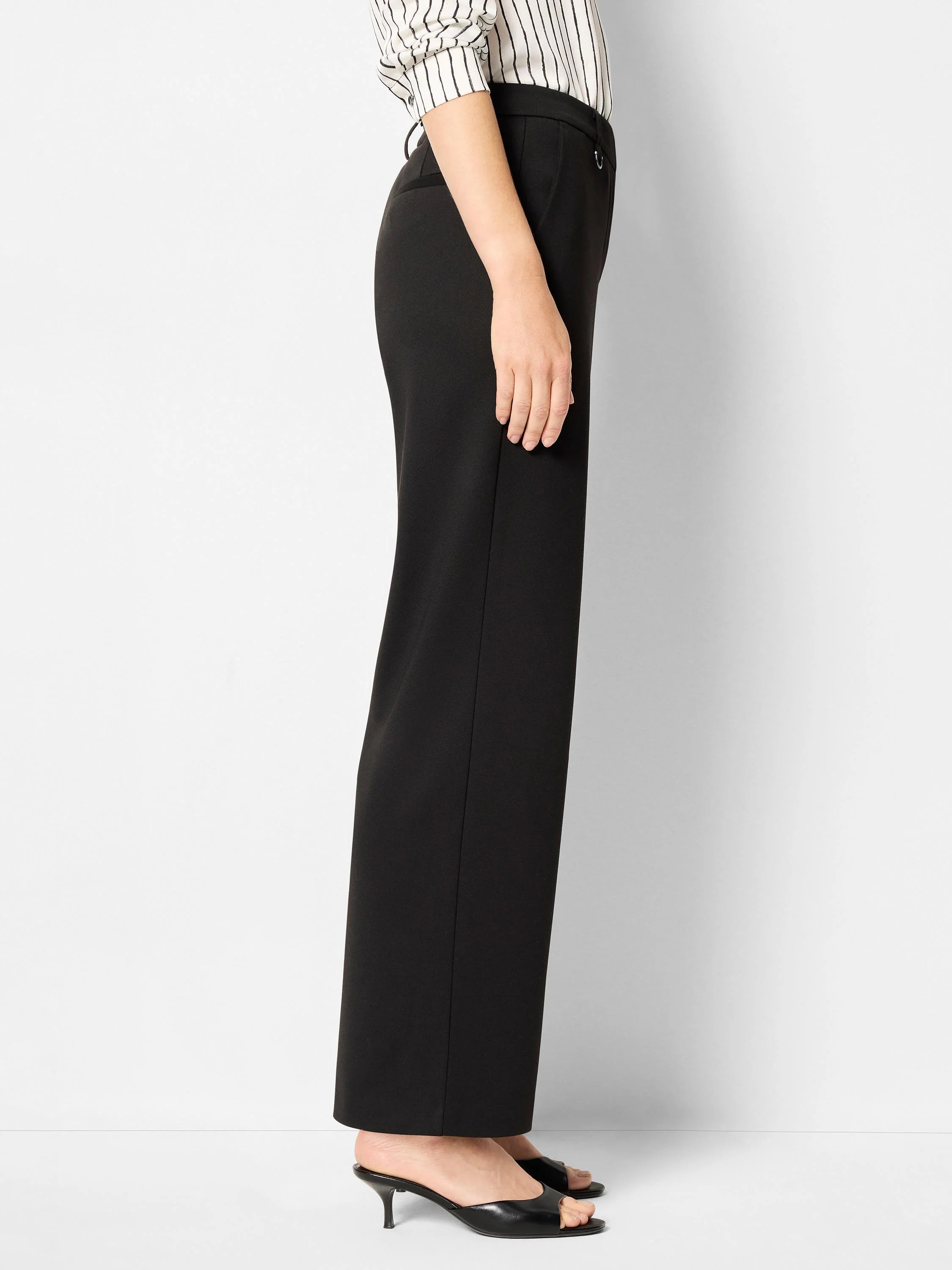 Black wide-leg pants; side view shows subtle buckle detail at waist.  Model wears black heels.
