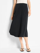 Black midi slip skirt; A-line shape.