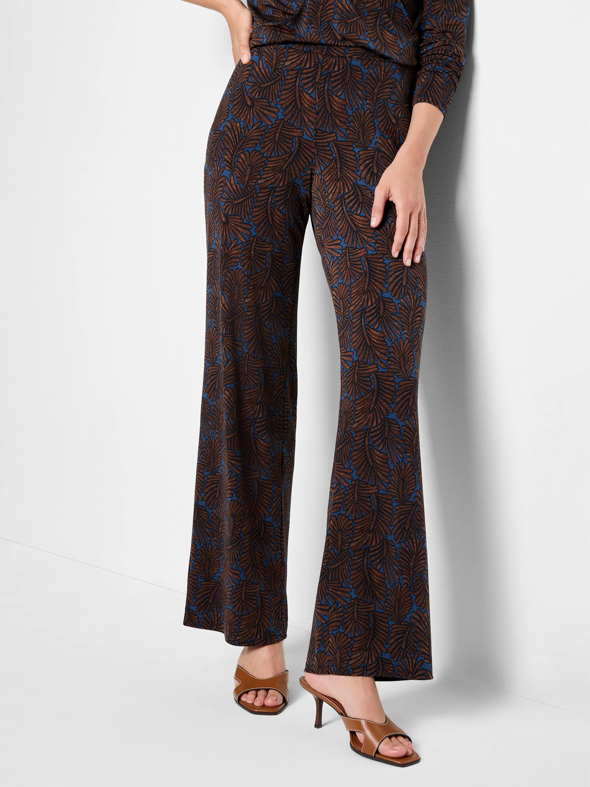 Wide-leg pants in dark teal with brown feather print.