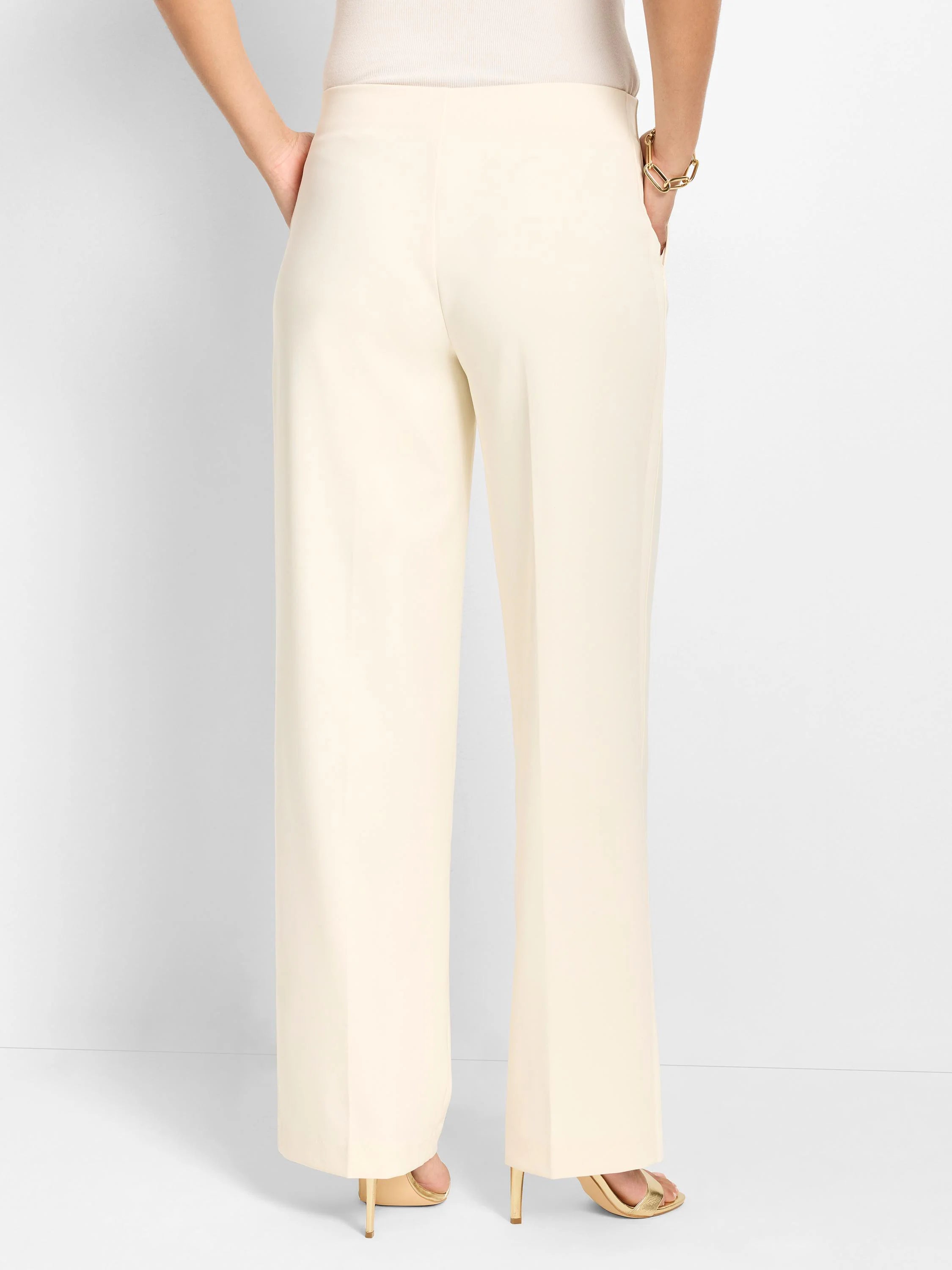 Cream wide-leg pants, full-length, with a smooth, sleek fabric.