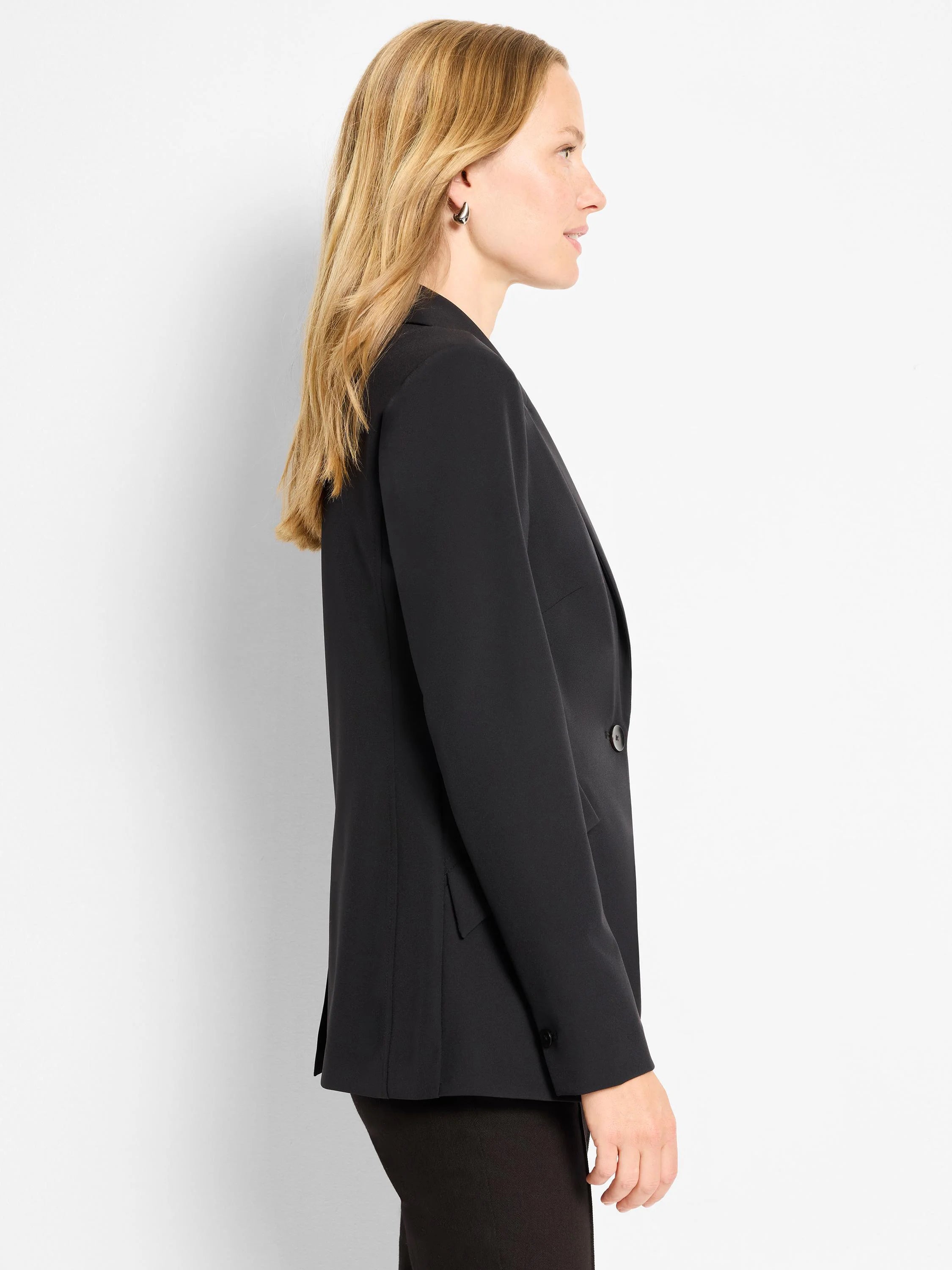 Black blazer, single button, shown in profile.  Long sleeves, tailored fit.