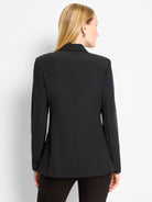 Black blazer, back view.  Structured shoulders, long sleeves, buttoned cuffs.