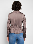 Mauve satin tuxedo jacket with long sleeves, button cuffs, and a cinched back.