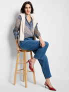 Shirt with a geometric monogram pattern in dark blue, light blue, cream, and orange-brown.