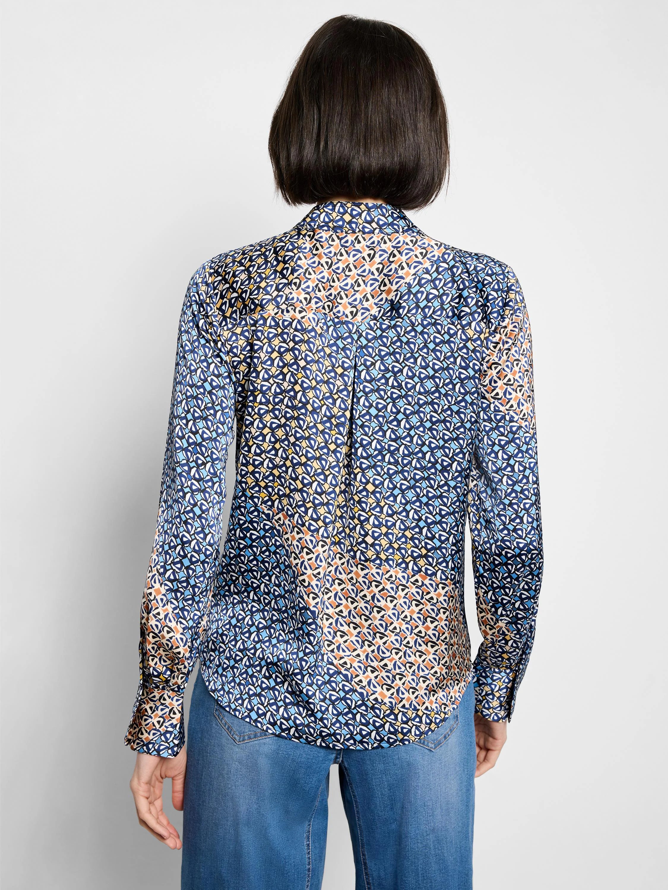 Long-sleeve top, back view, with a multi-blue, yellow, and orange geometric pattern.