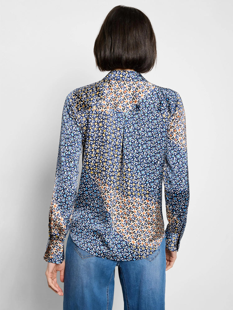 Long-sleeve top, back view, with a multi-blue, yellow, and orange geometric pattern.