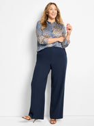 Blue, cream, and tan geometric print top with ruffled mock neck and long sleeves.