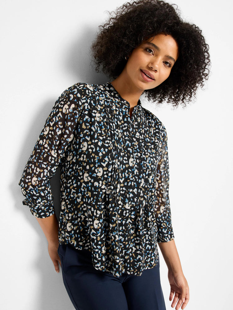 Black top with cream, blue, tan abstract spot pattern, stand collar, pleated front, and 3/4 sleeves.