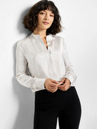 Off-white, long-sleeved satin shirt.  Mandarin collar, V-neck placket.