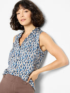Sleeveless top, blue, brown, and white brushstroke pattern. Ruffled neckline.