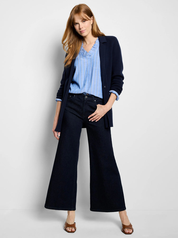 Blue and white striped top with ruffled neckline; navy blue cardigan and wide-leg jeans.