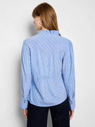 Blue and white striped blouse with ruffled neckline and long sleeves.  The stripes are diagonal.