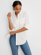 White button-down shirt with ruffle trim, chest pocket, and rolled sleeves.