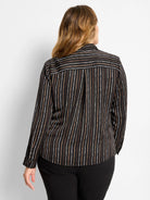 Black shirt with white, tan, brown painted vertical stripes. Upper back yoke has horizontal stripes.