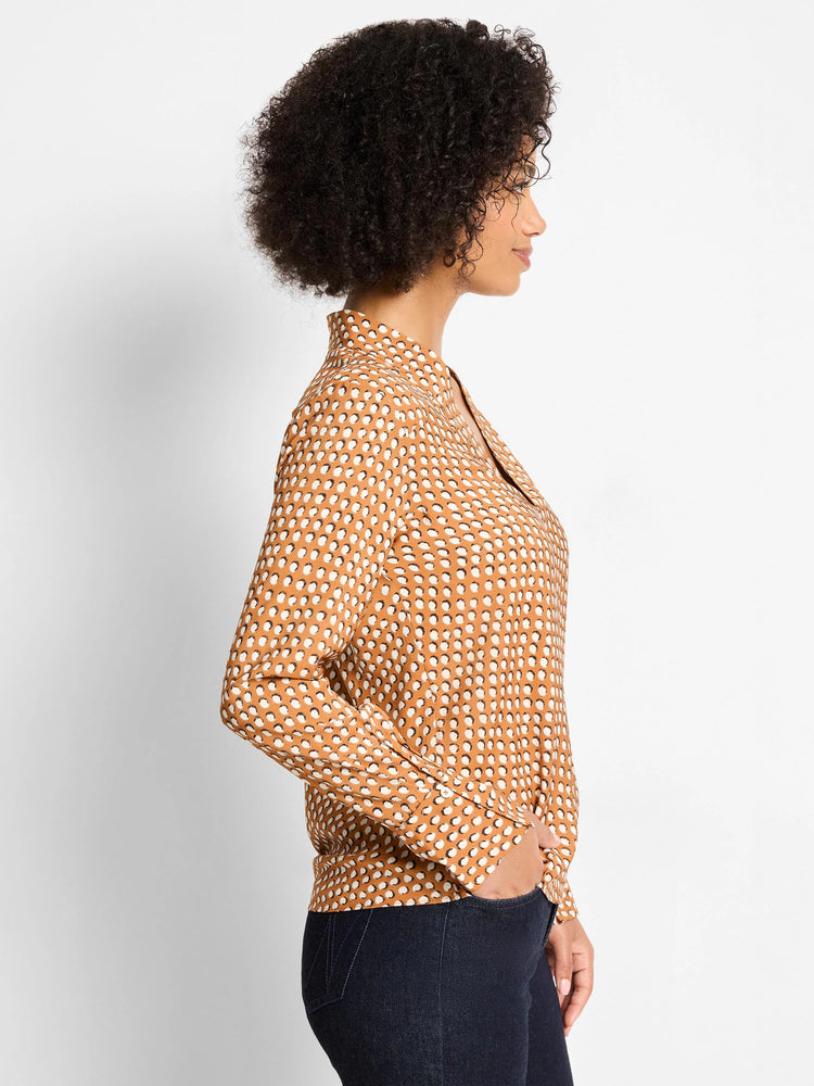 Caramel blouse with white shadow dots, stand-up collar, V-neck, and long sleeves.