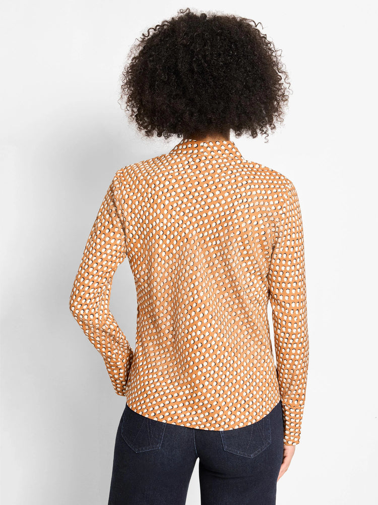 Tan long-sleeve top with a repeating pattern of white shadow dots, shown from the back.