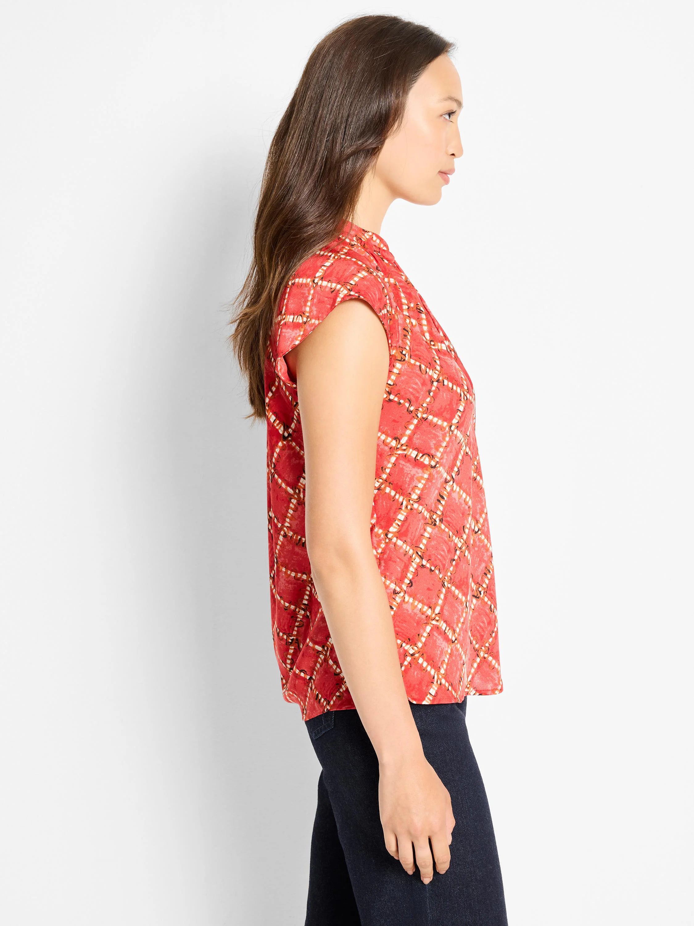 Red cap sleeve top with a high neck, featuring a white & tan squiggle diamond check pattern.