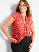 Red cap sleeve top featuring a light-colored squiggle check pattern with dark brown accents and a tied V-neck.