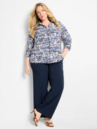 Collared button-up top with a navy, light blue, beige, and white scattered dot pattern, 3/4 sleeves.
