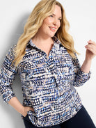 Harvest Dot Top: Collared shirt with abstract dot pattern in navy, white, light blue, purple, and tan. Rolled sleeves.