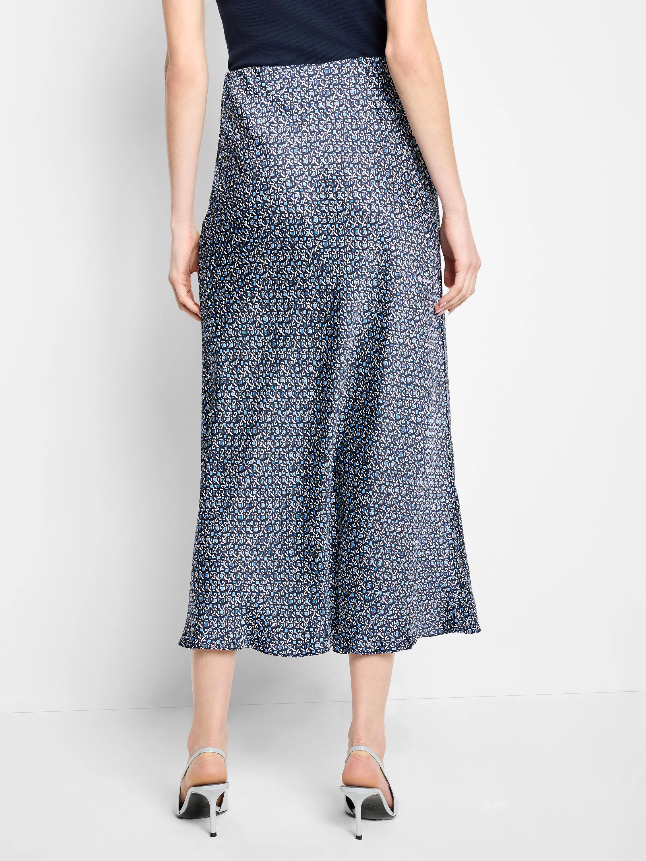 Midi slip skirt, dark-blue base with a light-blue and white repeating geometric pattern.  A-line silhouette.