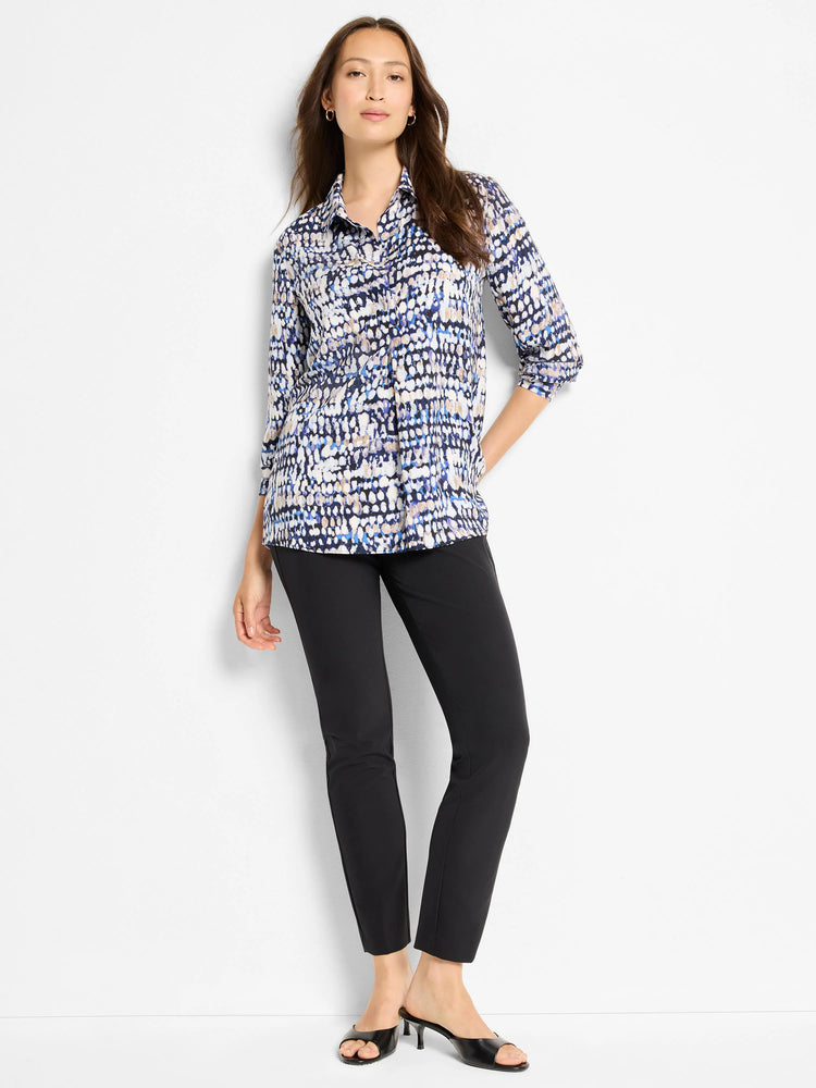 Black slim-fit pants shown on a model.  The model also wears a patterned shirt with blue, beige, and white abstract print.