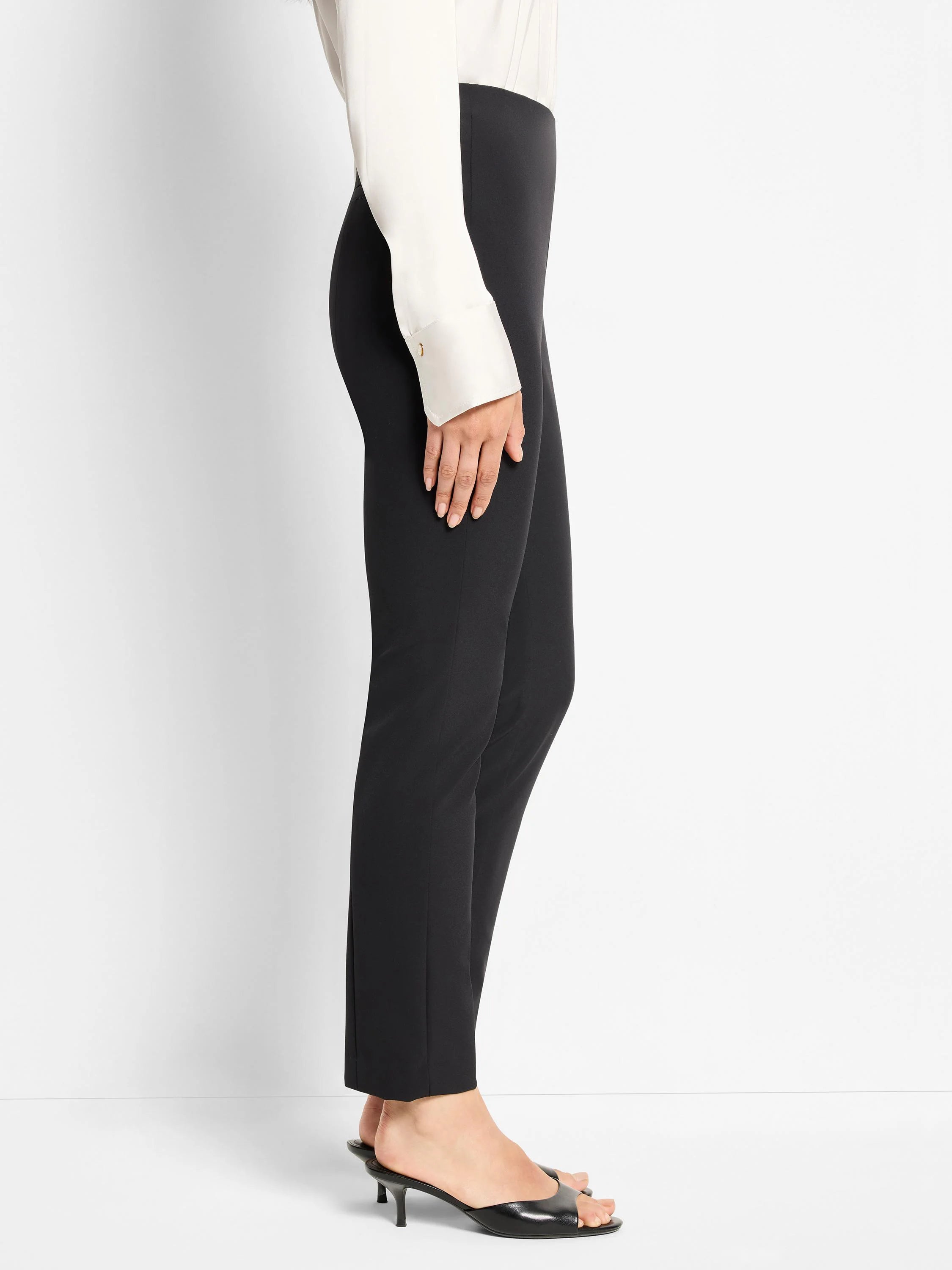 Black slim-fitting nylon pants shown on a model;  straight leg, cropped at the ankle.