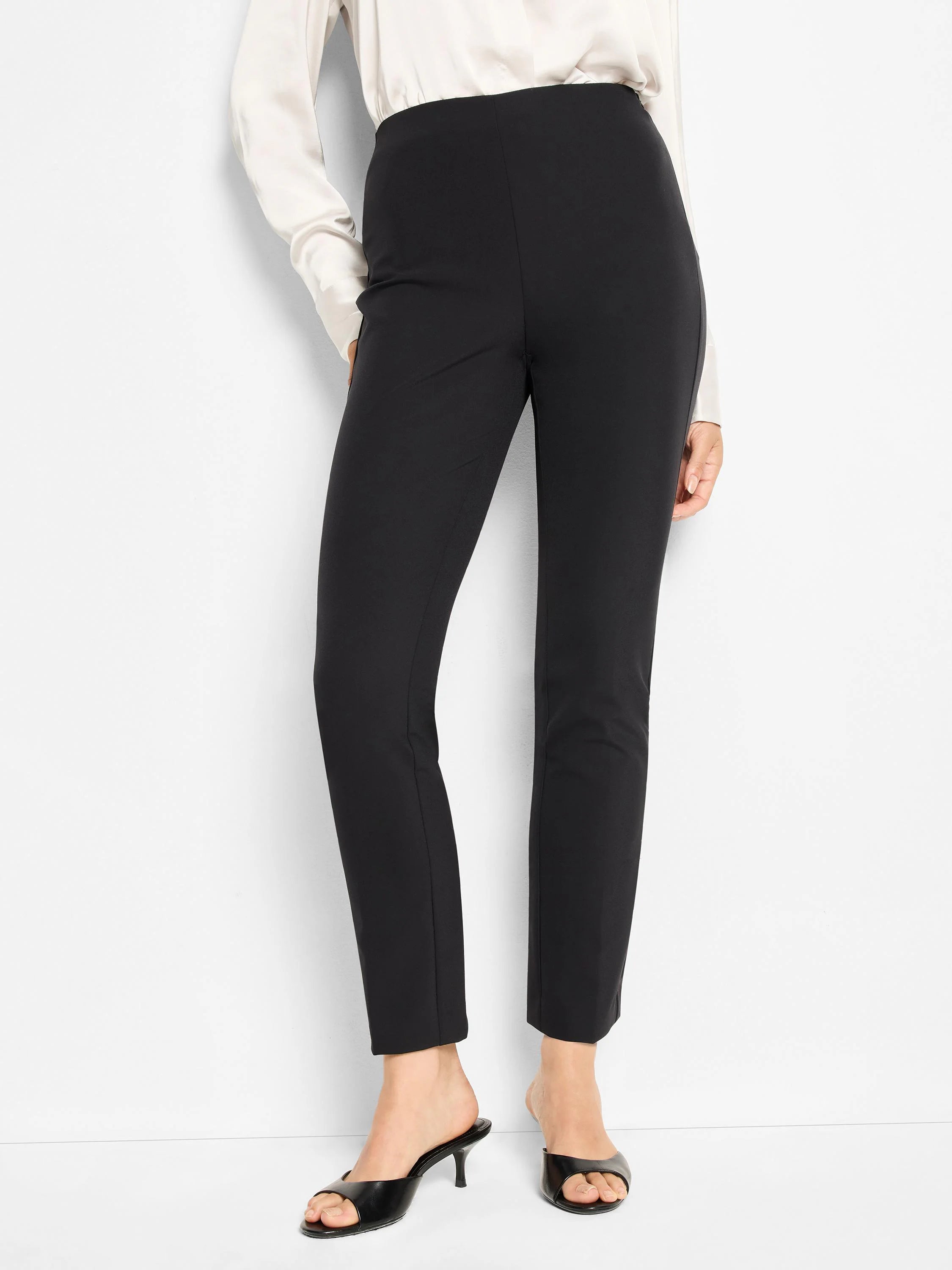 Black slim-leg pants; straight cut, high waist.  Model wears black heels.