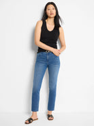 Medium blue denim jeans with a straight ankle cut and subtle fading.