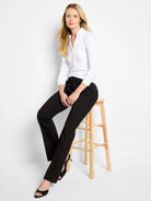 Black bootcut mid-rise trousers on a model.  Slight flare at ankle.
