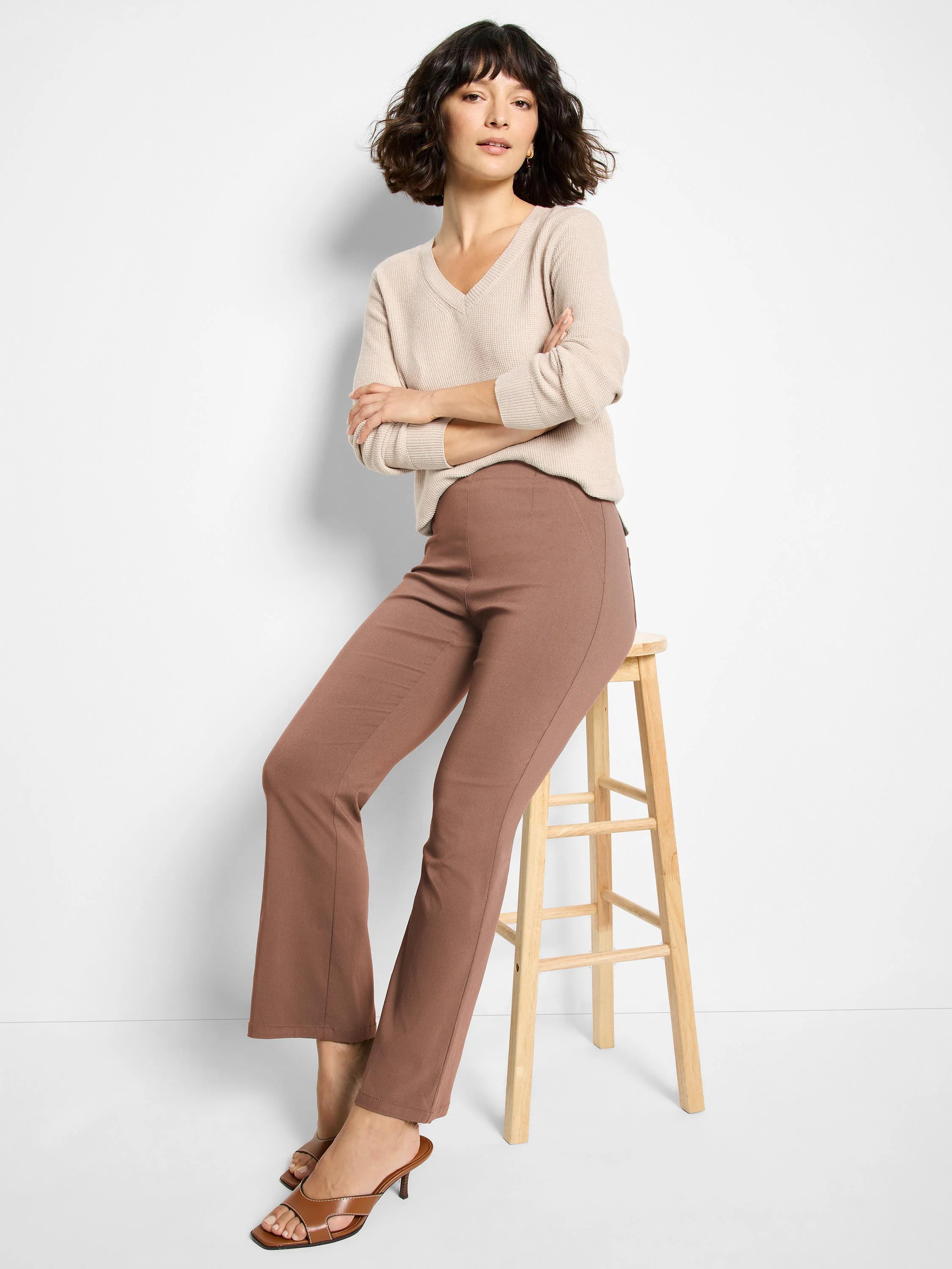 Mauve brown bootcut pants on a model, featuring a smooth finish and subtle vertical leg seams.