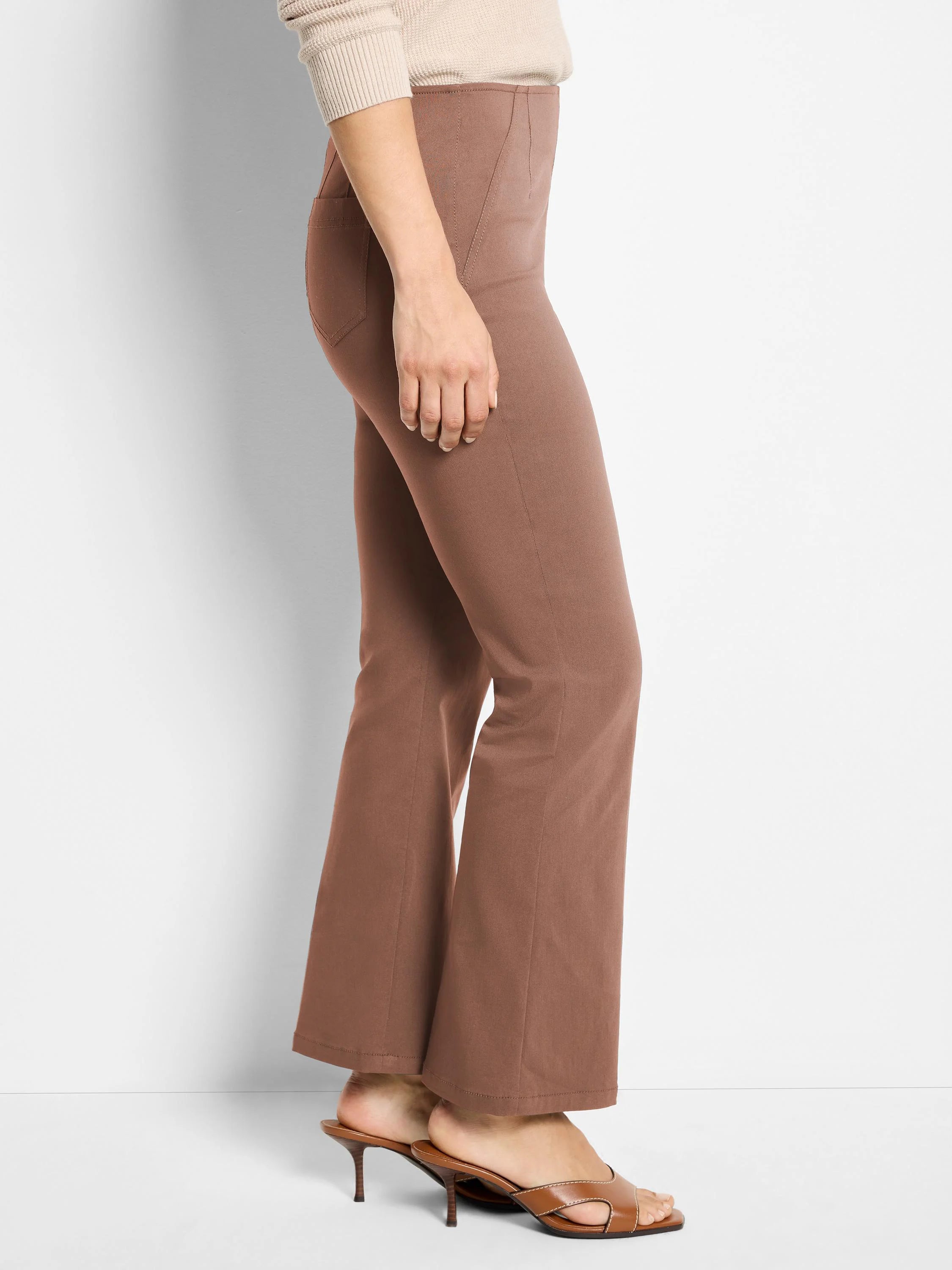 Brown high-waisted bootcut pants with visible seams and a smooth fabric finish.
