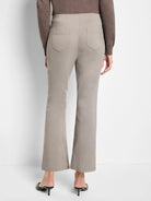 Light taupe bootcut pants shown from behind, featuring back patch pockets with visible stitching and a smooth waistband.