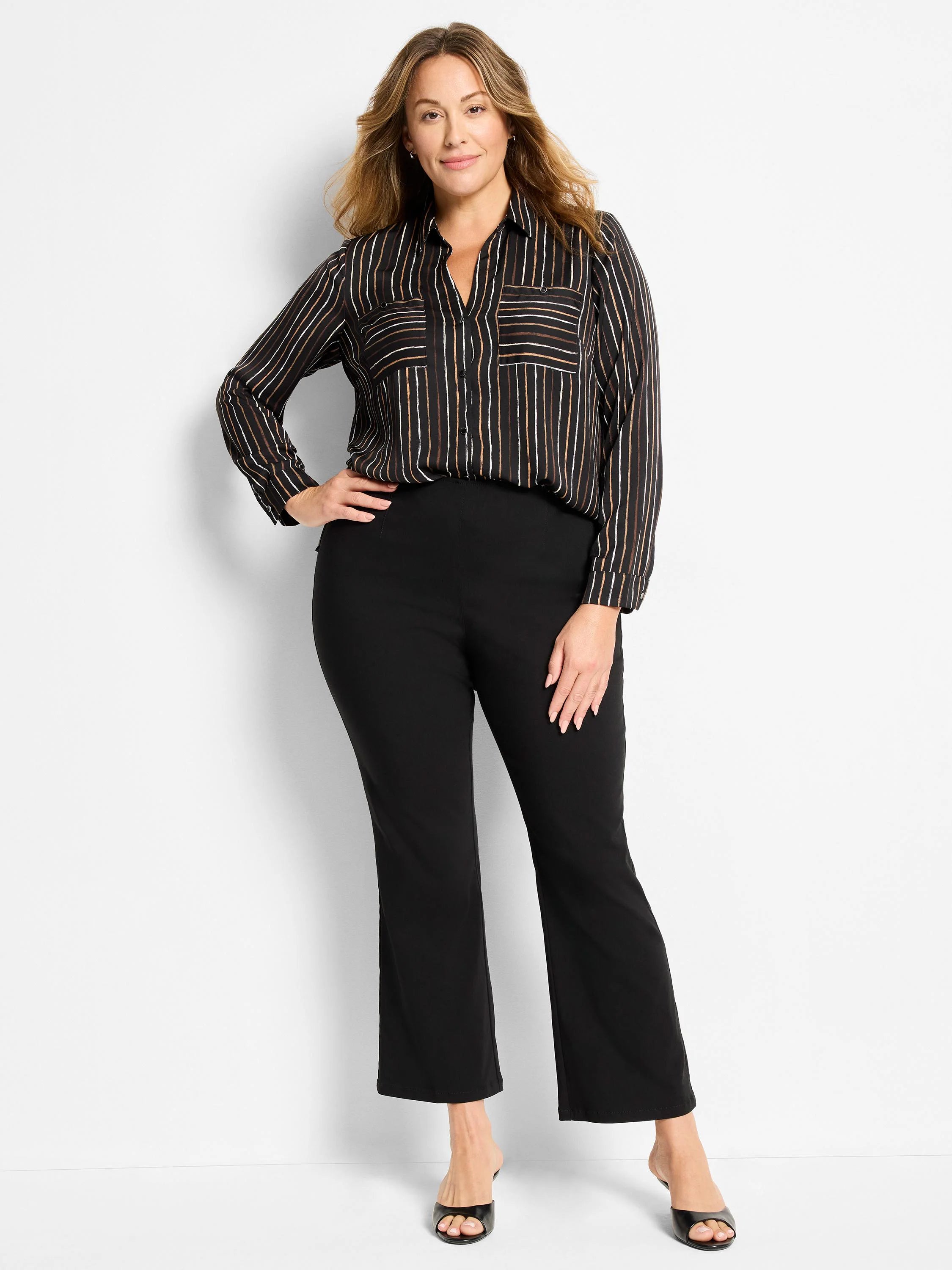 Black bootcut pants on a model, cropped length ending above the ankle.