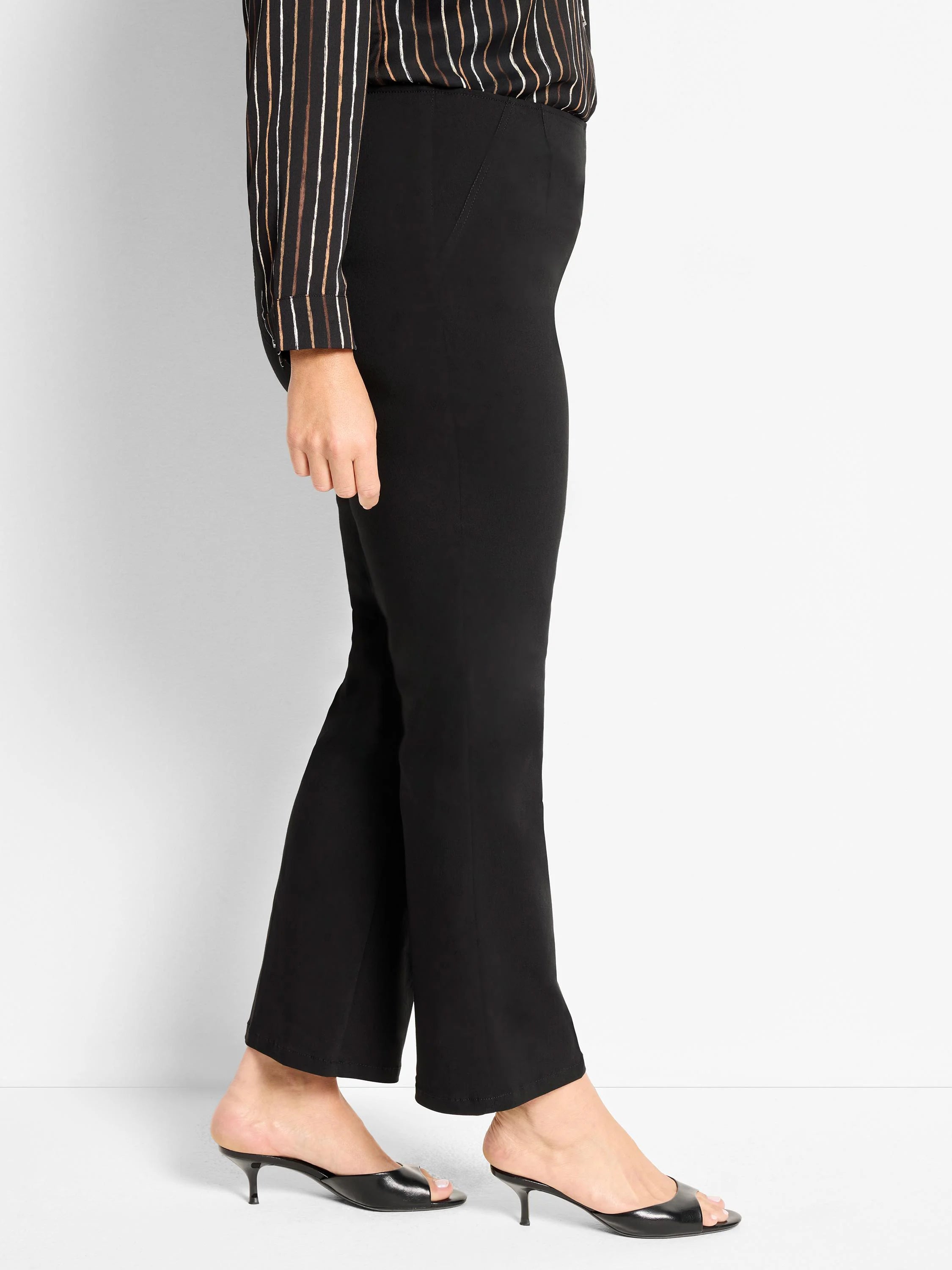 Black wonderstretch bootcut pants, shown worn on a model from waist to ankle.