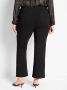 Black high-waisted bootcut pants with back pockets, shown from behind.