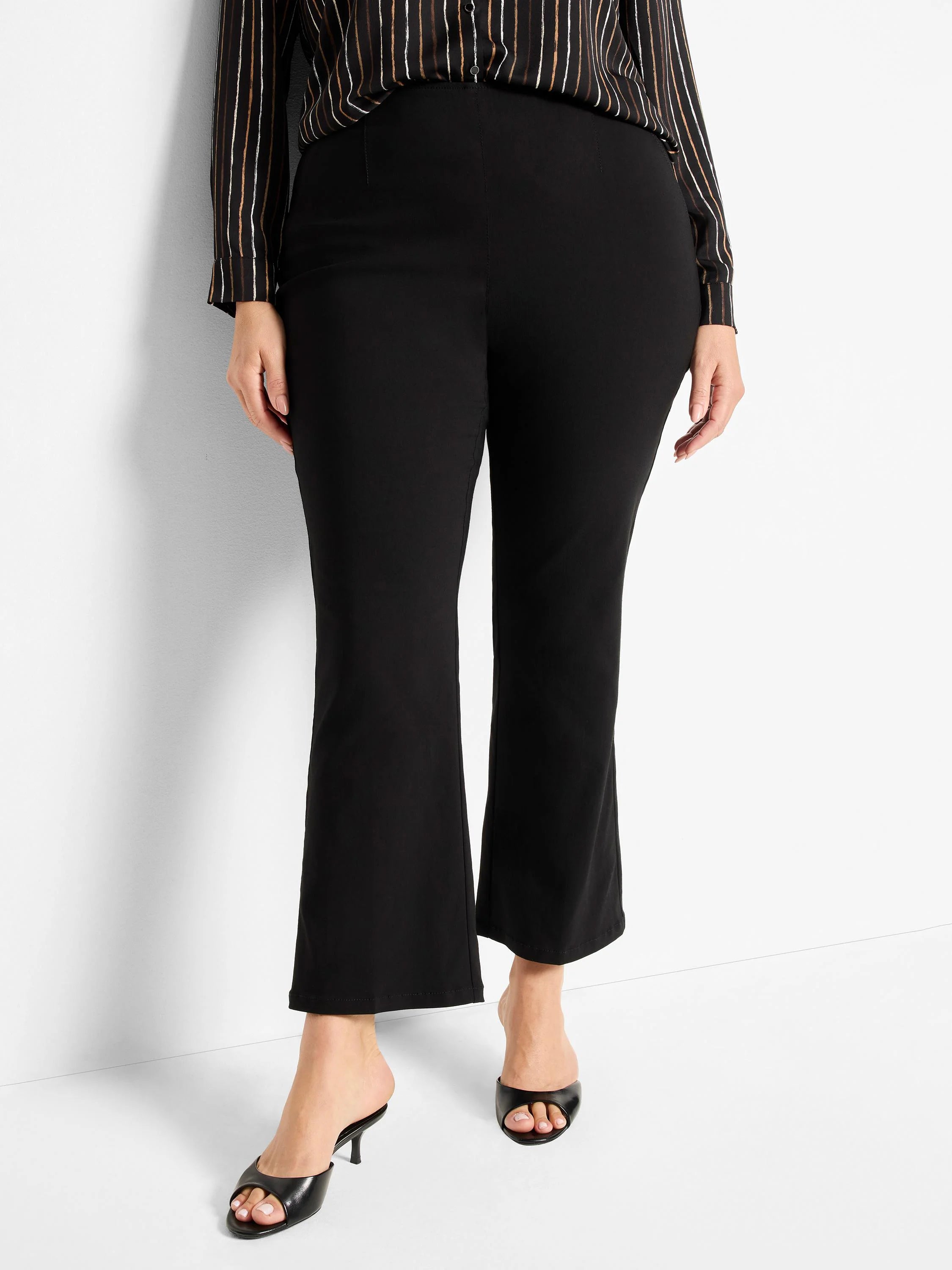 Black bootcut pants with a slight flare at the ankle. Smooth, black fabric.