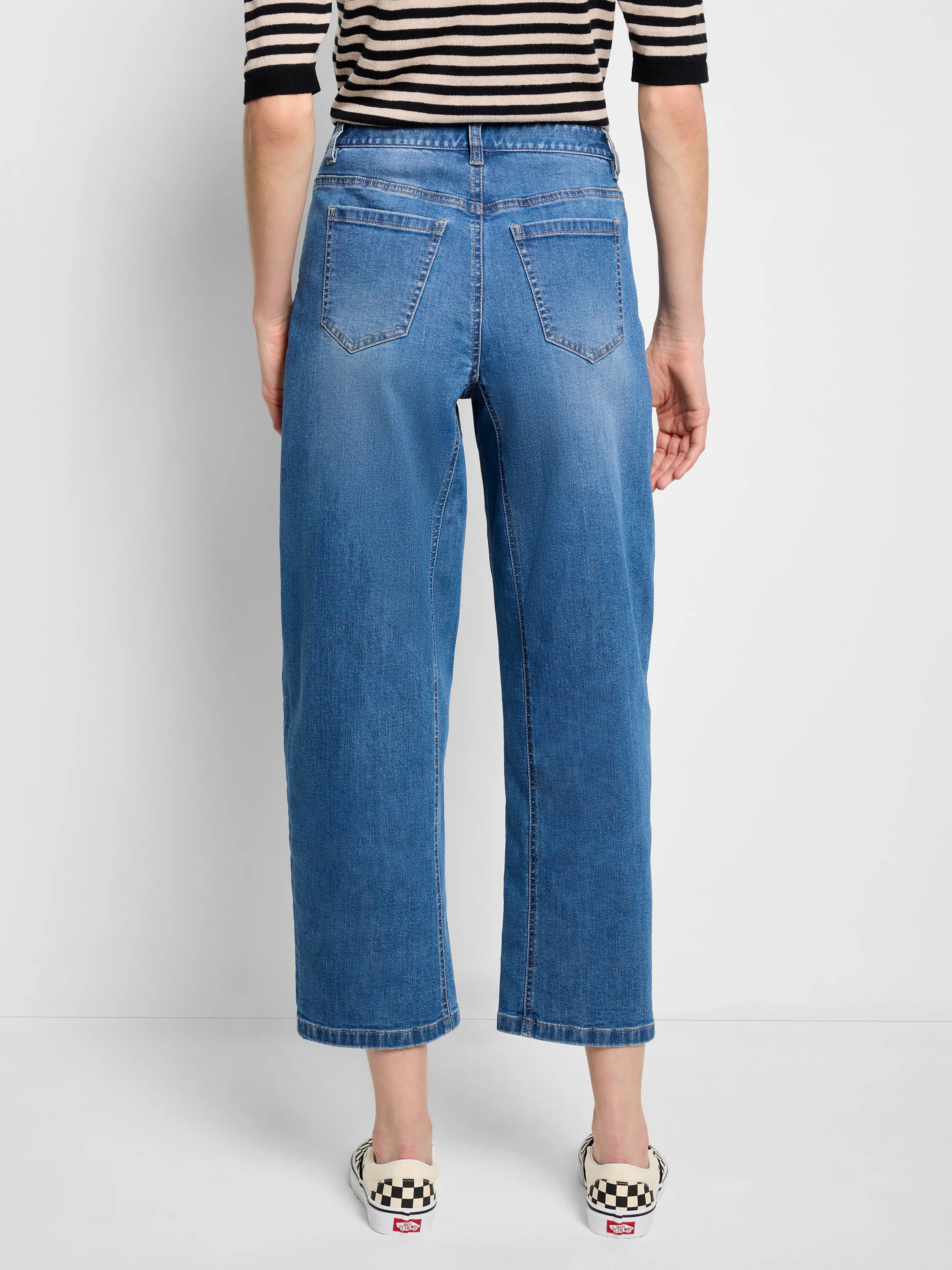 Medium blue barrel leg jeans with a relaxed, wide, cropped fit. Visible back pockets and subtle fading.
