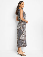 Black sleeveless midi dress with white and brown palm tree print. Boat neck.