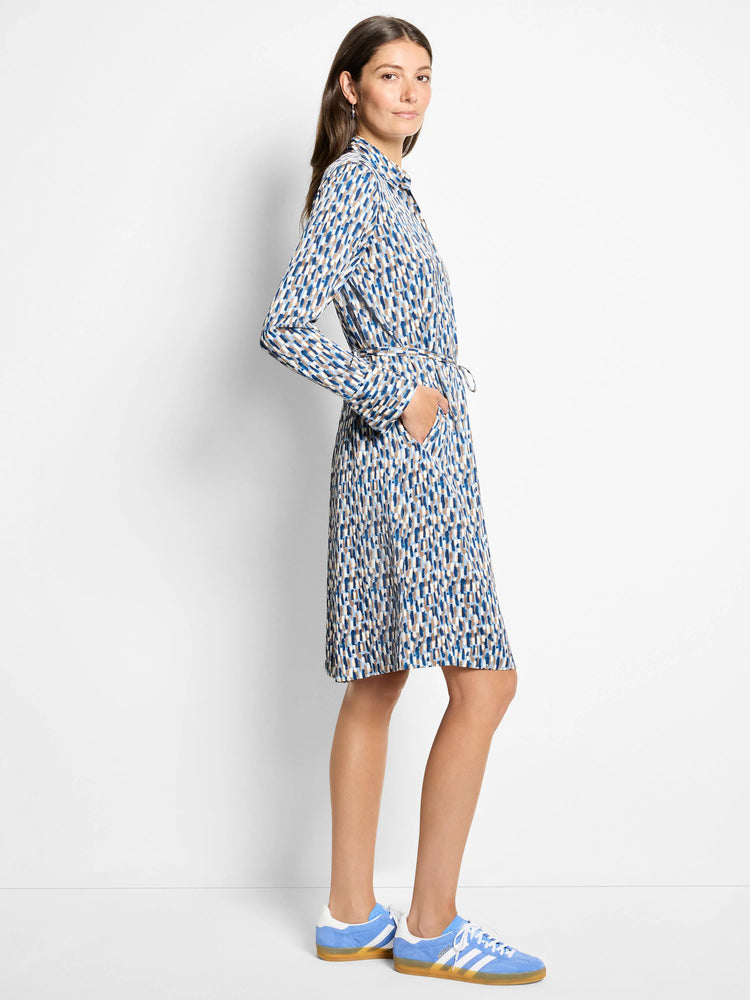 Long-sleeved knee-length dress; off-white background with blue, brown, and beige brushstroke pattern; belted waist; pockets.