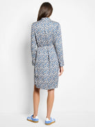 Long-sleeved knee-length dress, belted.  Blue, beige, and white brushstroke pattern.  Back view.