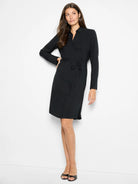 Black long-sleeved mini dress with a belted waist.  Shirt collar.