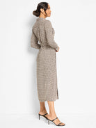 Cream, black, and tan abstract dot midi shirt dress with long sleeves and a tie-waist.