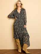 Black cheetah print maxi dress; off-white, blue, tan spots. V-neck, sheer sleeves, smocked waist, tiered design.
